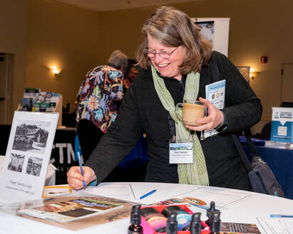 Vermont Tourism Summit attendee bidding on silent auction items